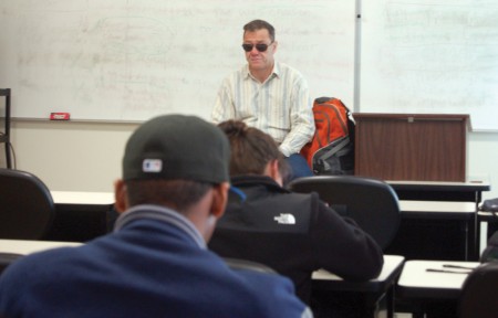 English instructor Andy Cooper lectures his English 201 class Friday. Cooper lost his eyesight at age 31 due to Type 1 diabetes. Now 52, he’s been teaching at George Mason University for 24 years. Photo By Gregory Connolly.